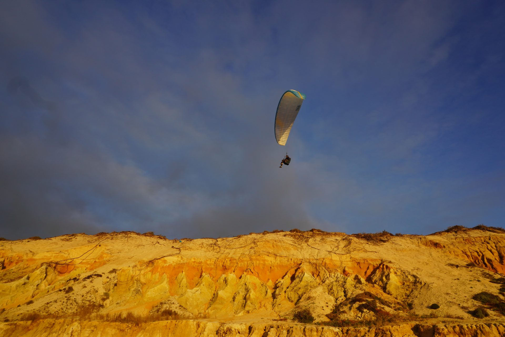 Parapente en soaring au-dessus des falaises dorées de la côte atlantique portugaise